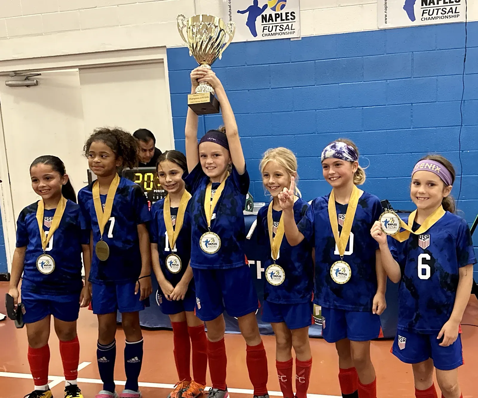 Young Lions lifting a trophy at the Naples Futsal Championship
